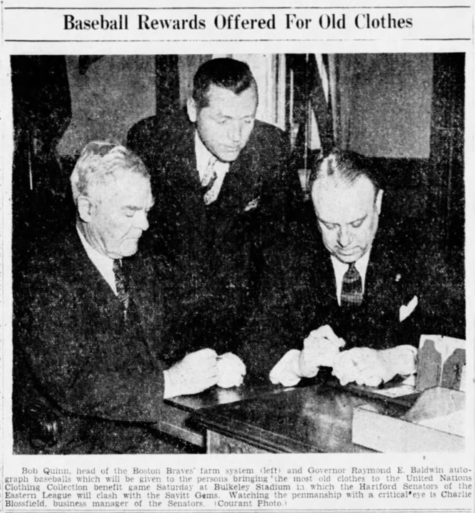 Bob Quinn, Boston Braves and Governor Raymond E. Baldwin of Connecticut sign balls for a clothing drive contest while Charlie Blossfield, Business Manager, Hartford Bees looks on, 1945.